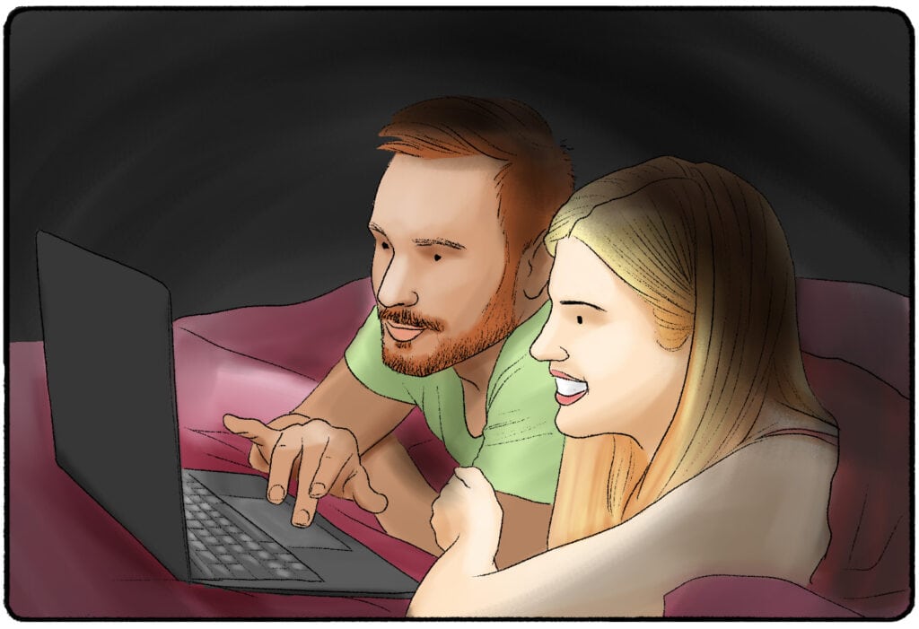 a man and woman looking at a laptop screen together