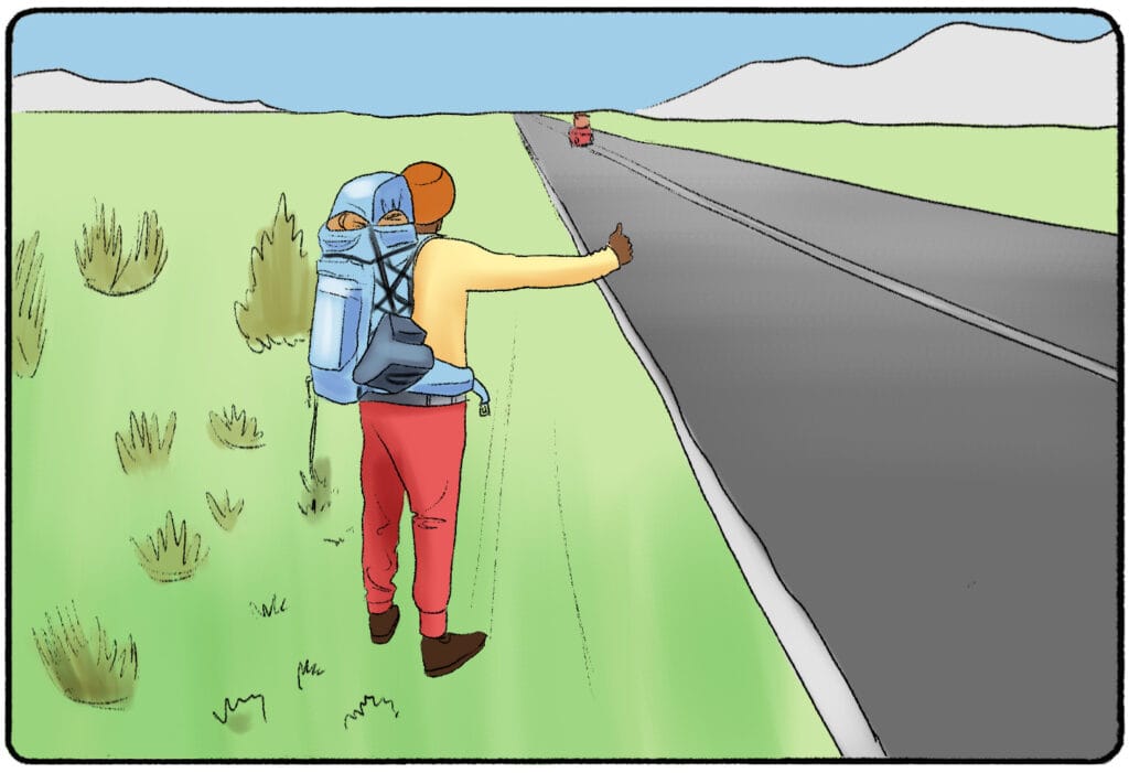 a man hitchhiking on the side of the road